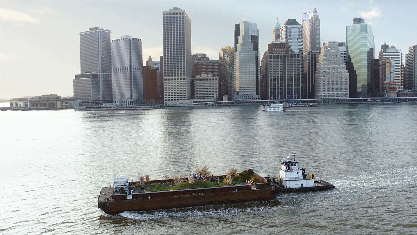 Barge planted with a garden sails past Lower Manhattan.