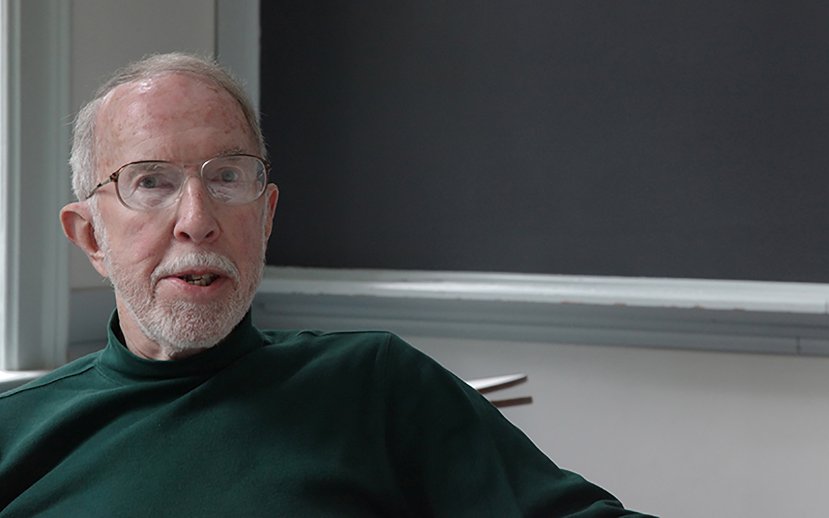 portrait of man in green turtleneck with glasses