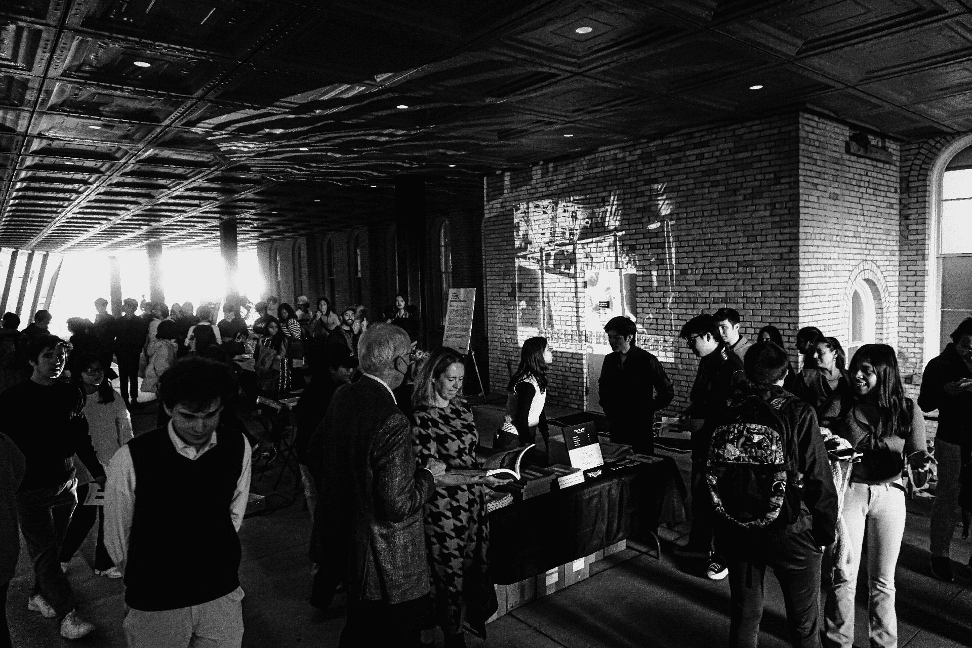 People gathered outside a brick building for a party