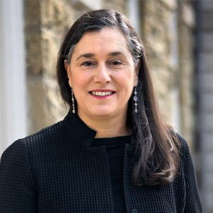 person in black coat smiling at camera