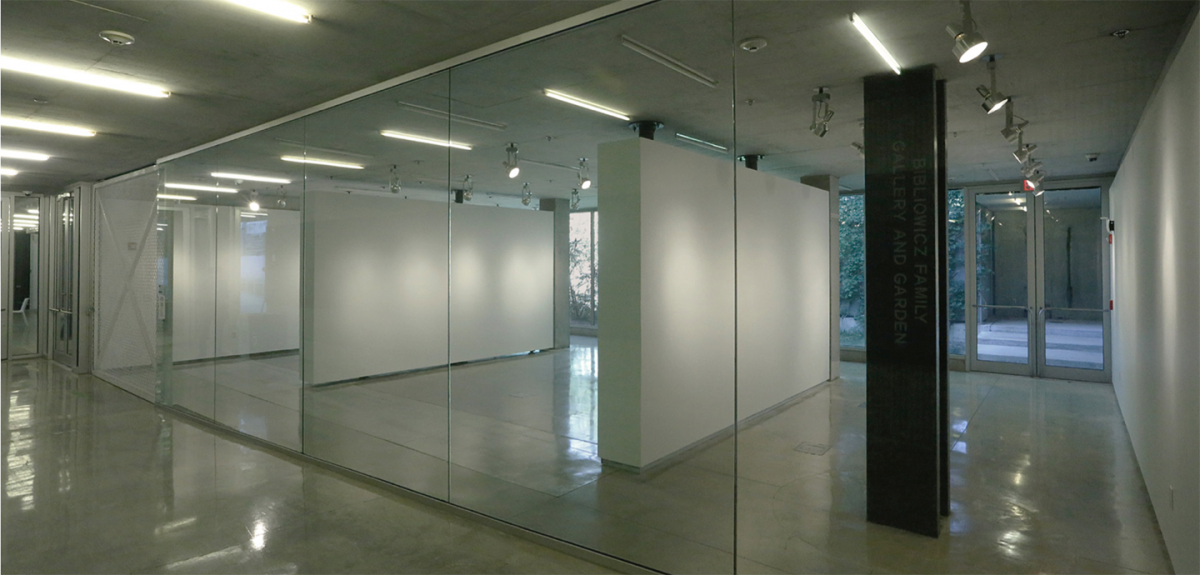 Hallway view into the gallery with a dark steel column and two room divider walls.