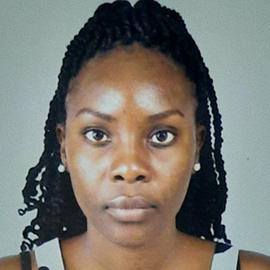 A person standing in front of a grey background.