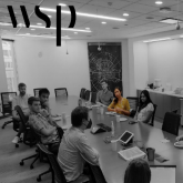 group of people sitting at a large meeting table