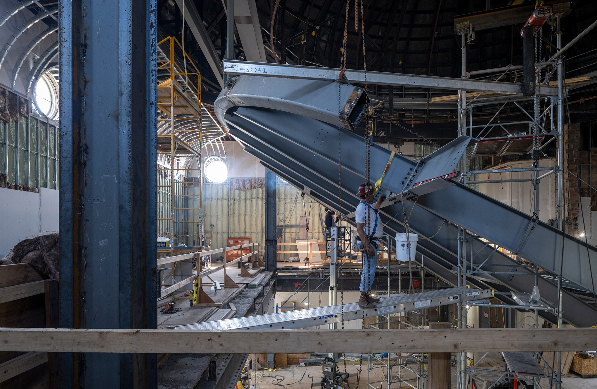 Construction worker moving large steel beam