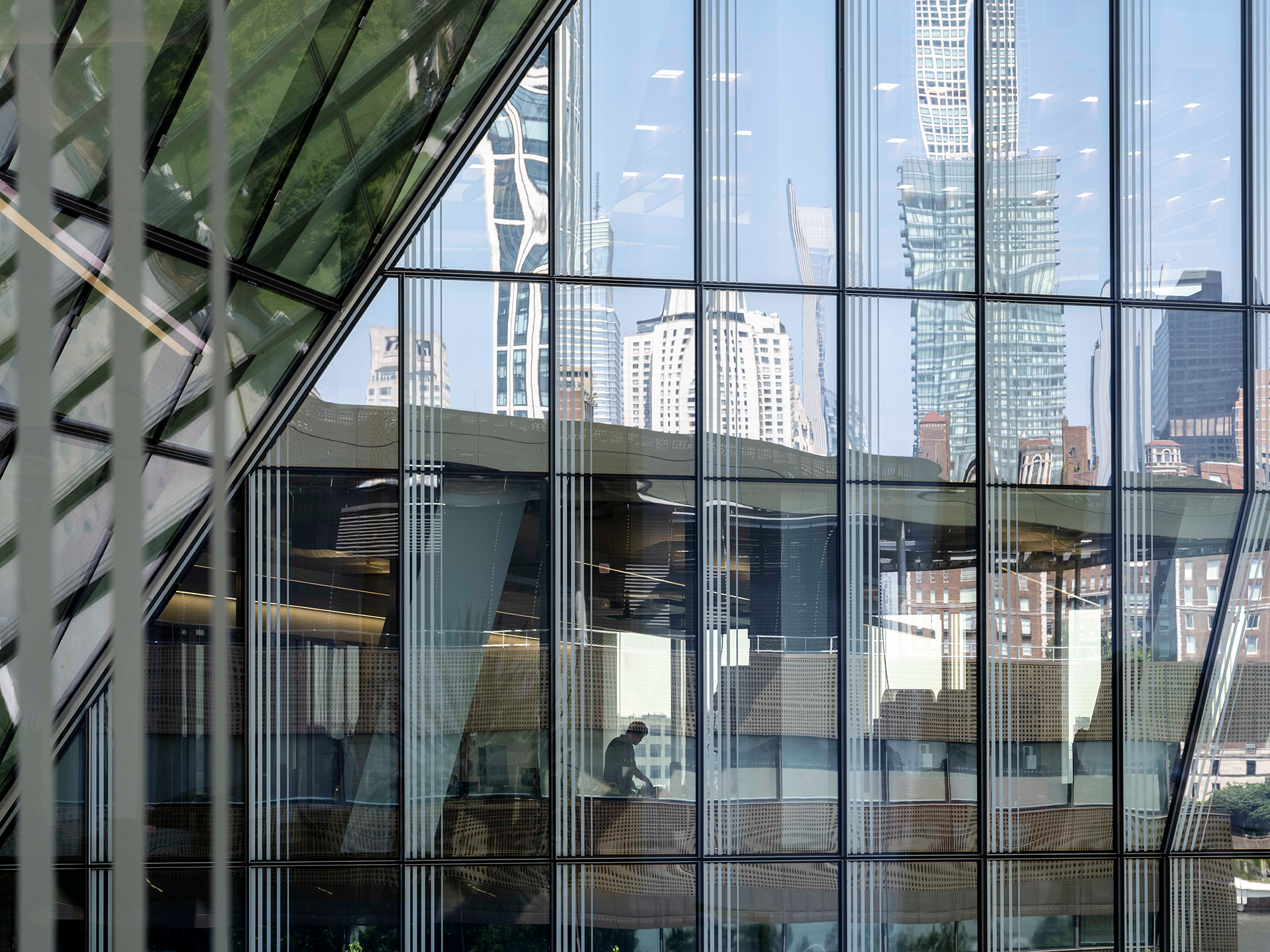 NYC skyline reflected by glass building