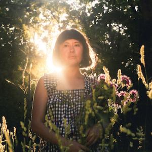 Woman standing among flowers