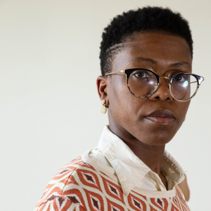 A woman with glasses looking at the camera