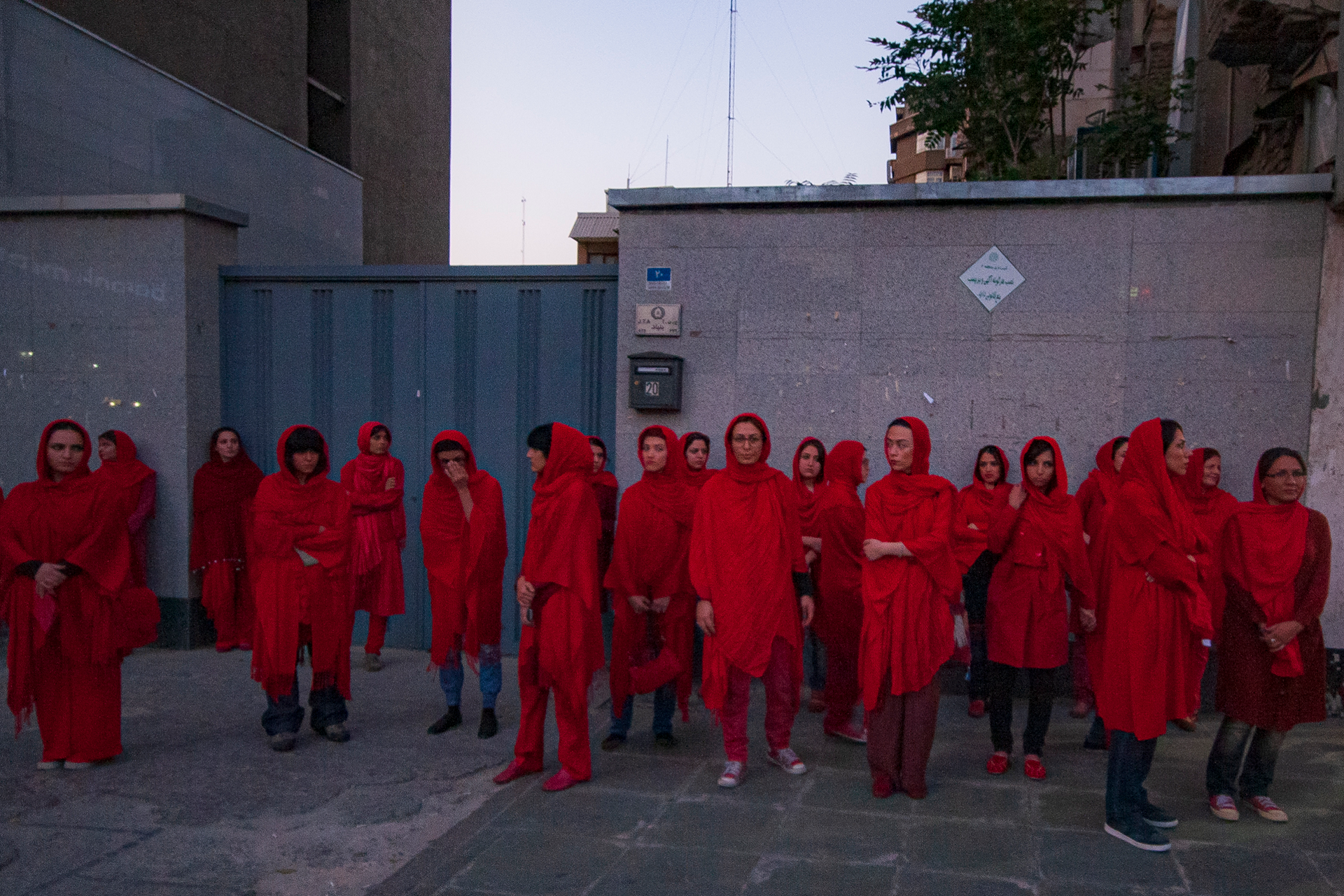Group of women standing in the street all wearing bright red