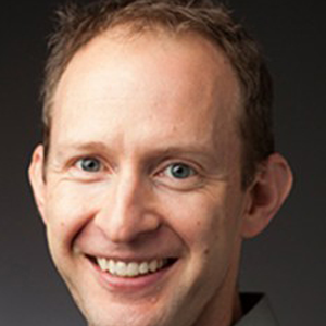 smiling man wearing a green shirt
