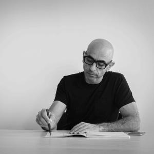 bald white man wearing black tshirt and black glasses