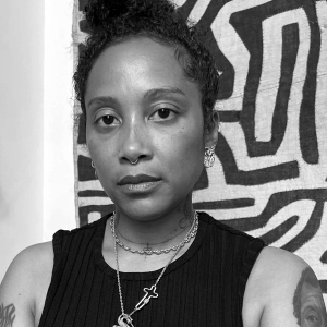 Woman wearing sleeveless top standing in front of an abstract artwork