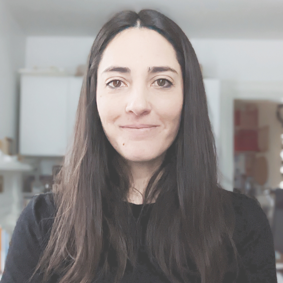 A person with long dark hair wearing a black shirt.