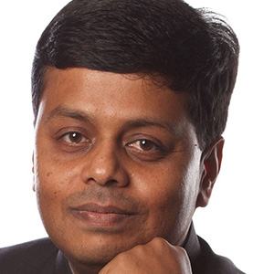 person resting their chin on their left hand and looking at the camera