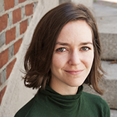 woman with brown hair and green turtleneck 