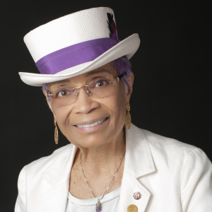 A woman wearing a hat smiling at the camera