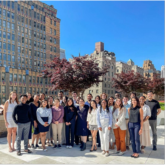 group outisde with city buildings in the backround 