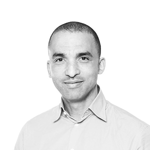 A man with a buzz cut wearing a collared shirt