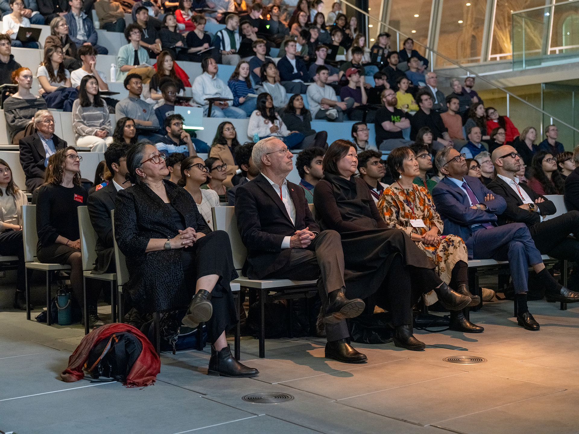Crowd gathered in a racked lecture hall
