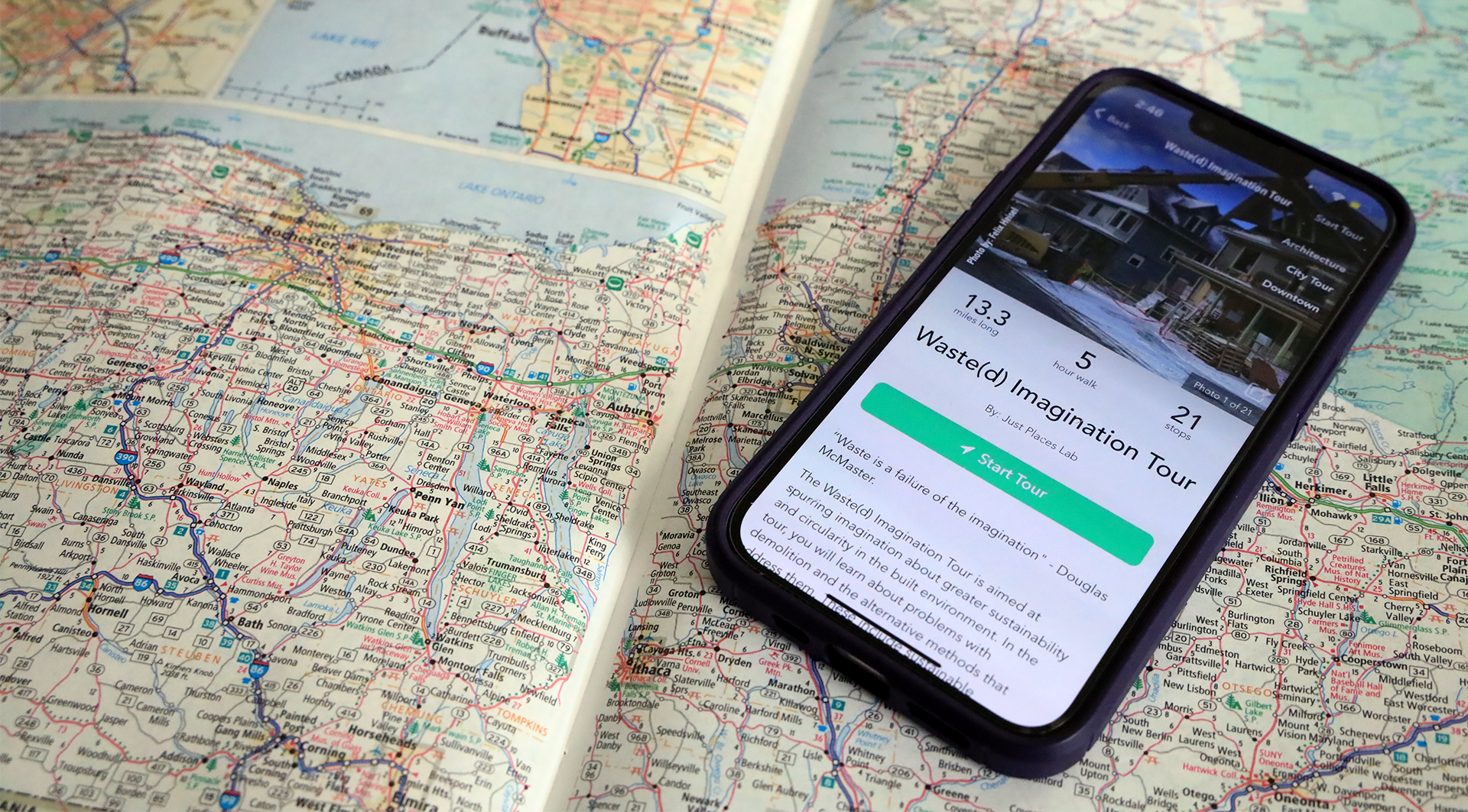 cellphone placed on top of a paper map