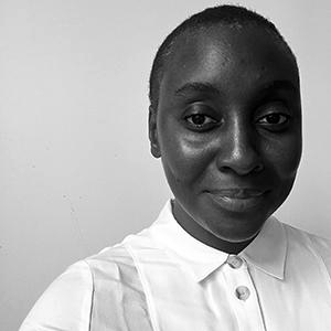 Woman in white blouse looking directly at the camera.