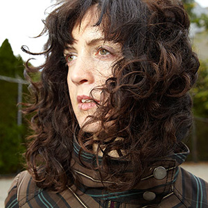 Person with hair on their face looking left