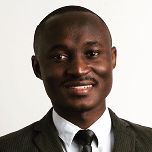 Smiling man in a dark suit and tie with a white button down shirt
