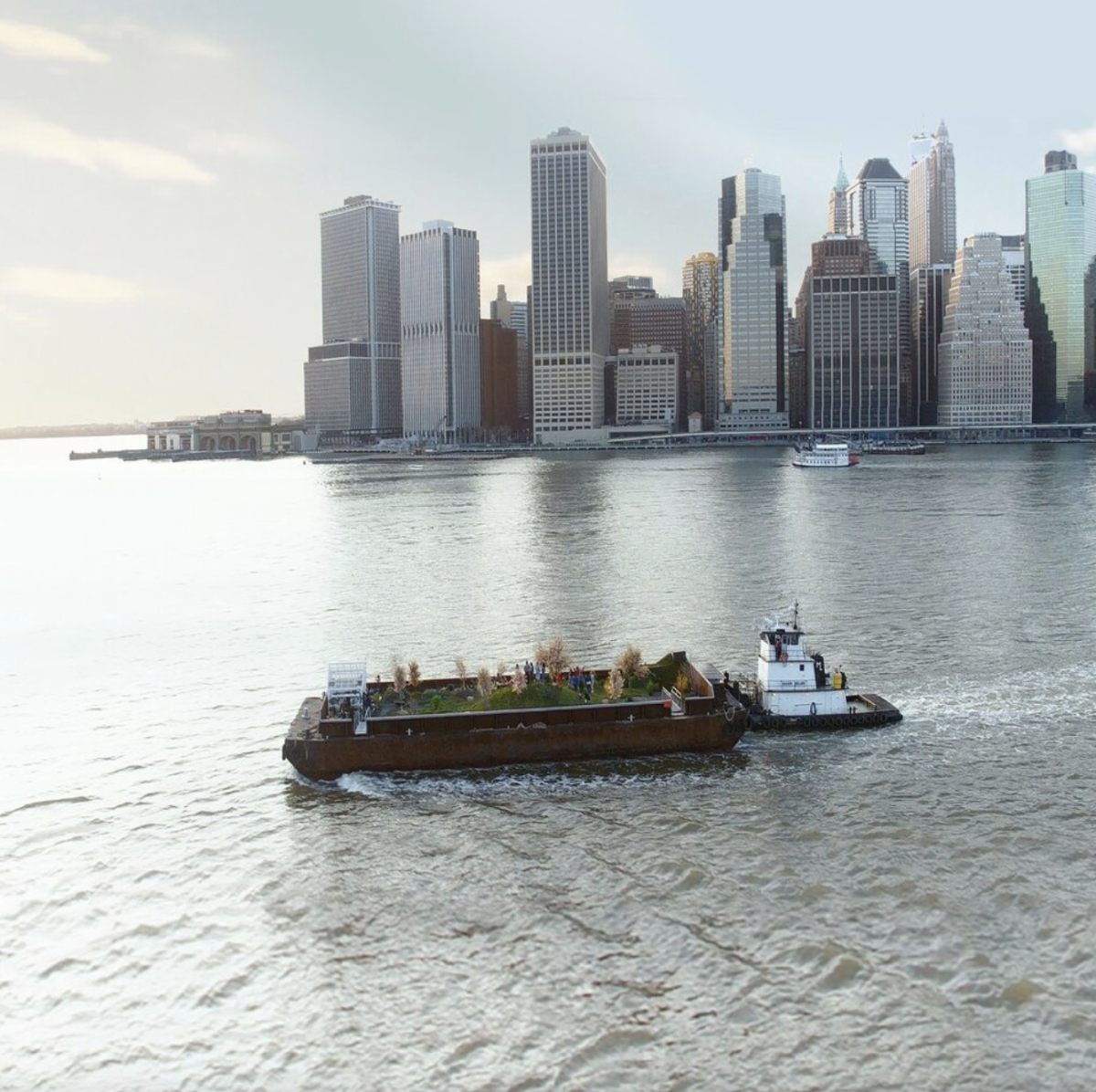Barge planted with a garden sails past Lower Manhattan.