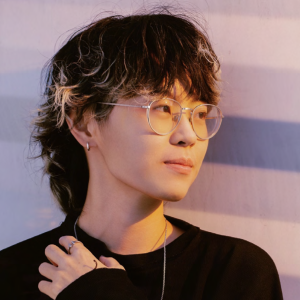 asian woman with short black hair and glasses in a black sweater