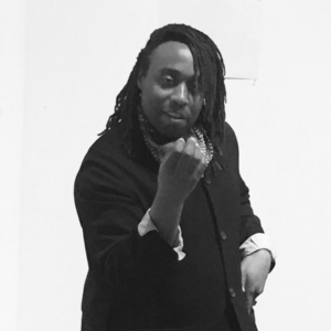 A man posing at the camera and smiling