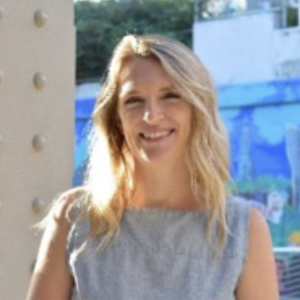 woman with medium blonde hair and grey shirt