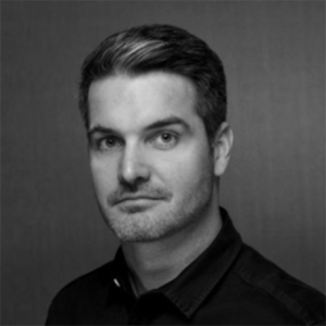 black and white photo of a man with dark button shirt