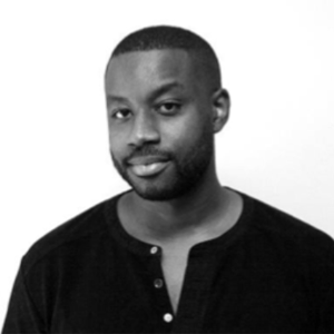 black and white photo of a man with short hair short facial hair and dark shirt