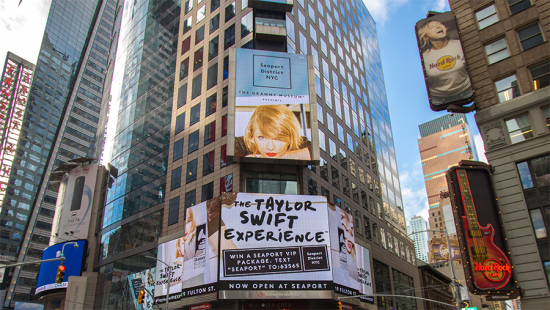 large buildings with advertisements on them.