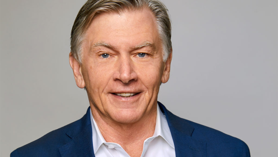 Person with blue eyes and grey hair looking directly at the camera