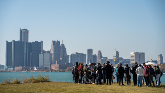 urban skyline viewed by a group on people from across a body of water
