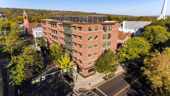 A large brick building surrounded by trees.