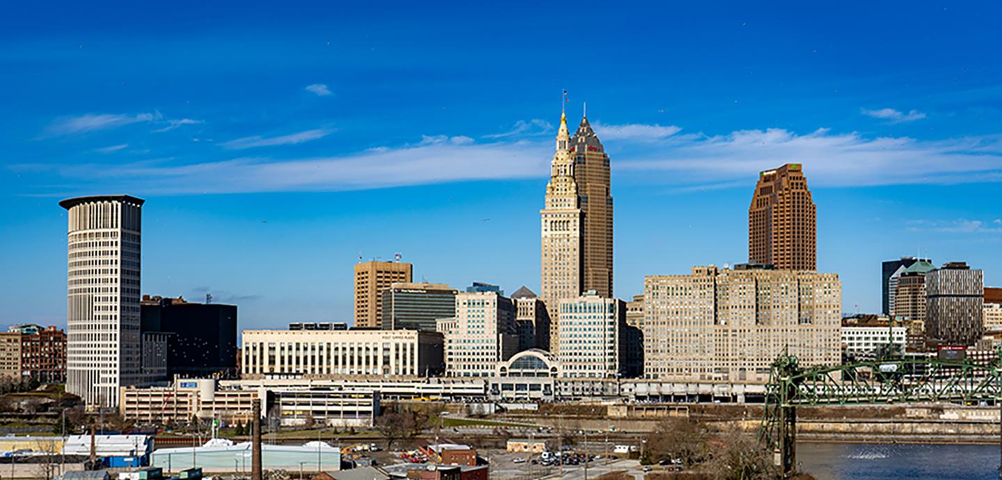 Cleveland city skyline with tall office buildings under a clear blue sky.