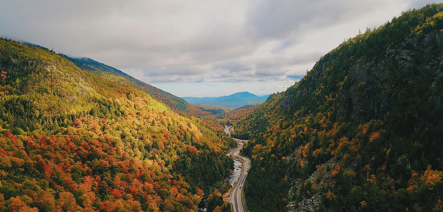 Aerial view of the Adirondack mountains transitioning into fall.