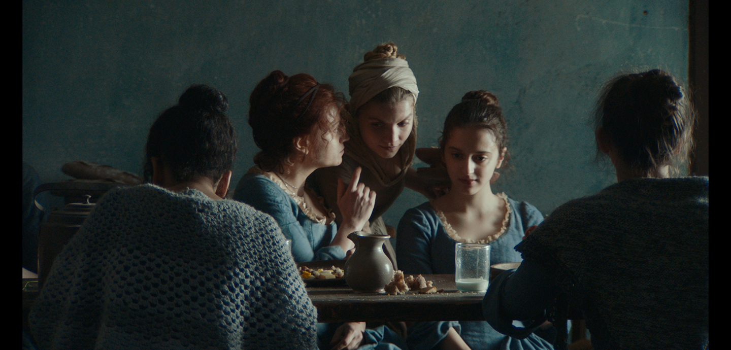 Image of a scene from Gloria! by Margherita Vicario, showing a group of young women in the Venetian institute, capturing the spirit of their hidden, rebellious world.
