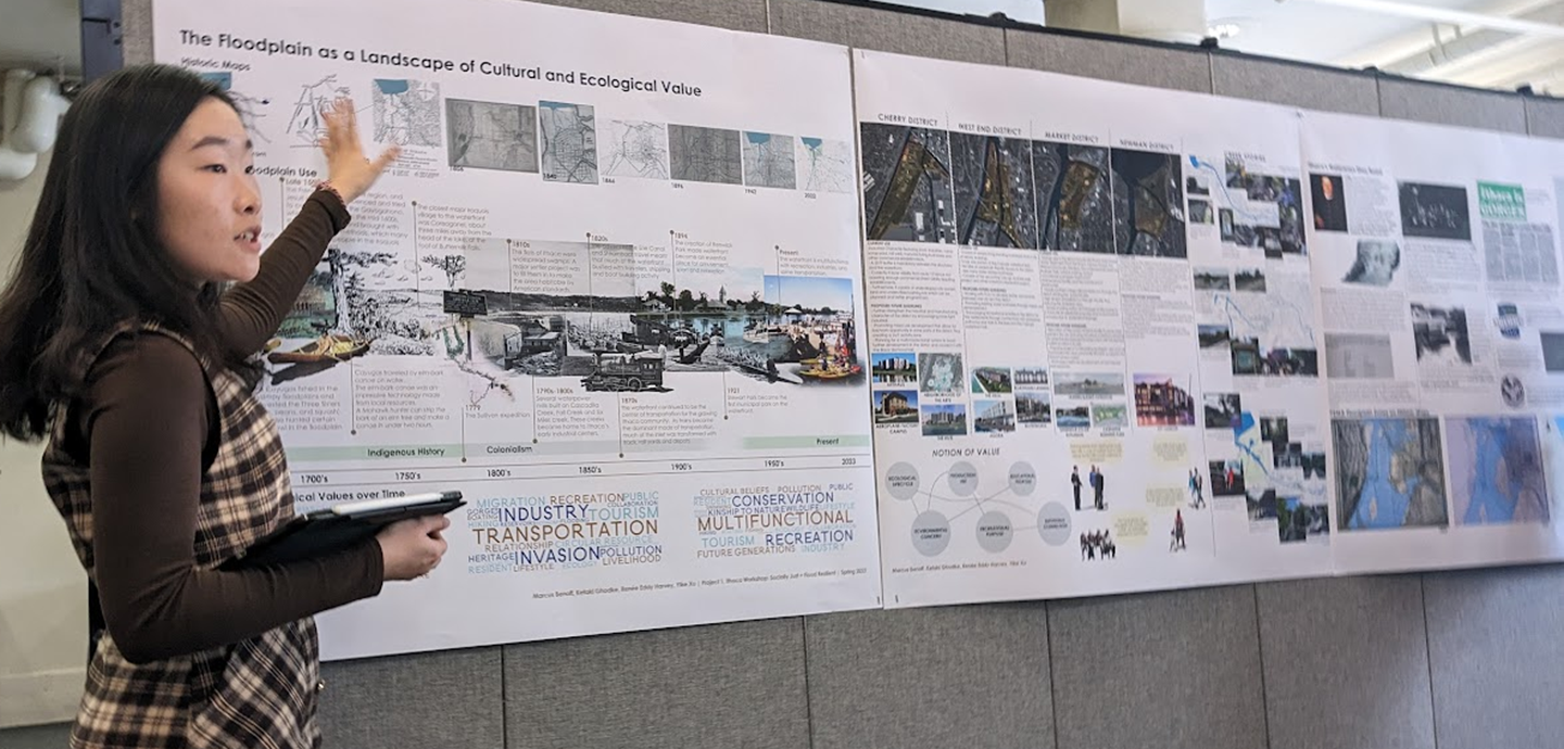 woman presenting beside a poster