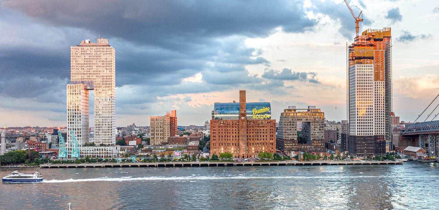 A series of buildings next to a body of water.