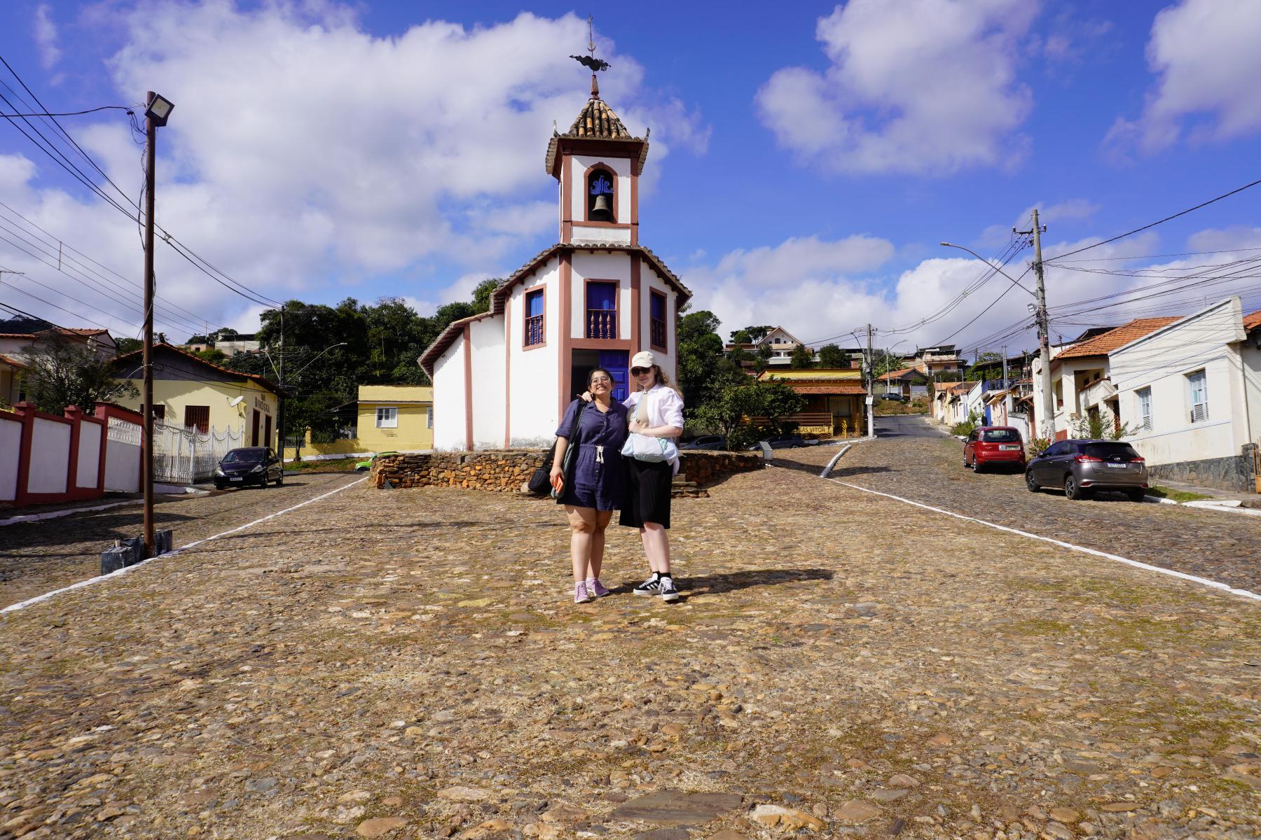 two women posing for a photo in front of an old church in Brazil