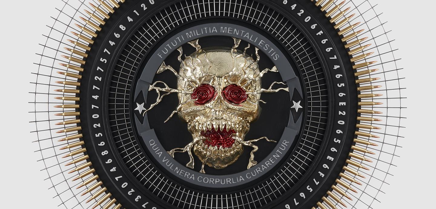 A gold skull with a red bejeweled mouth and eyes, set against a black circular background.