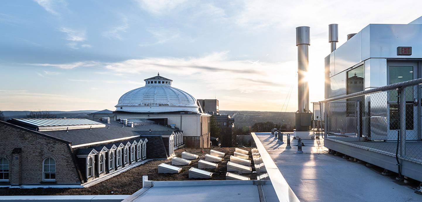 A white dome seen from far away among a blue sky and clouds