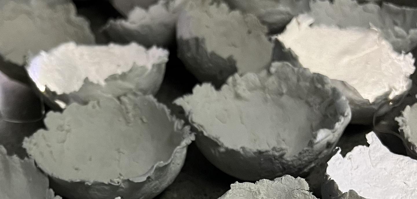 A large assortment of papier-mache bowls in varying sizes.