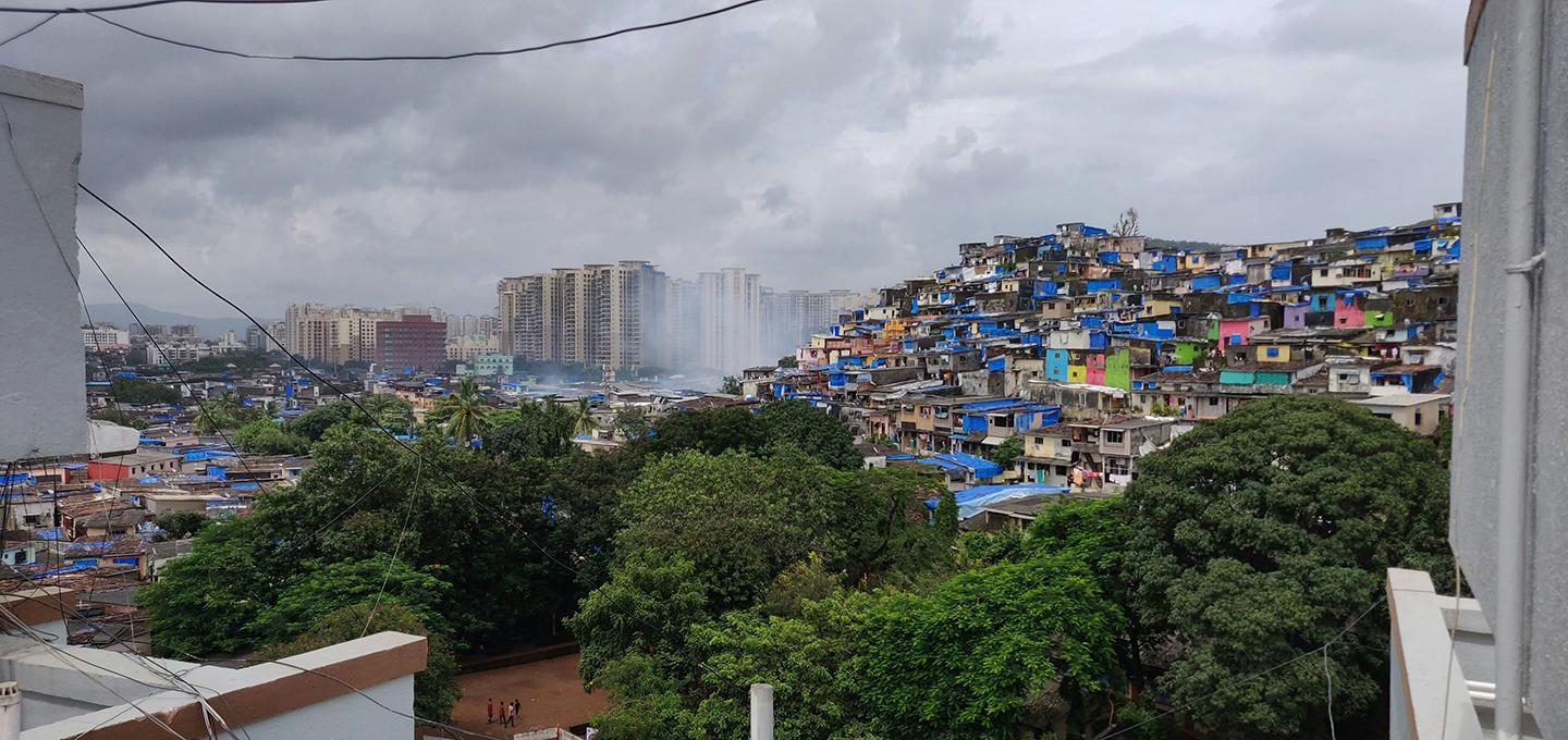 A colorful slum next to high rise buildings