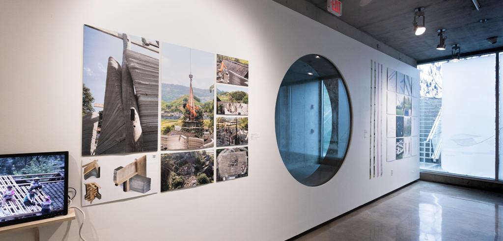 A large gallery wall with a circular window and artwork.