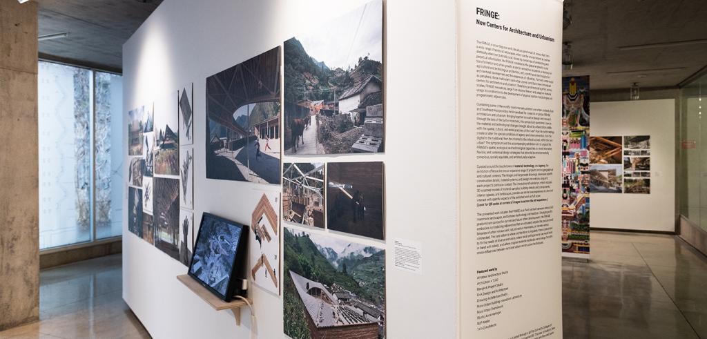 Art work and television screen on a gallery wall.