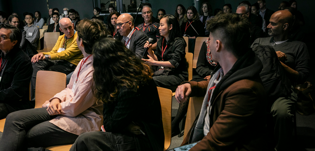 People sitting in chairs in an auditorium.