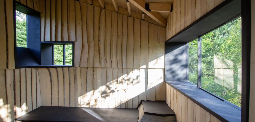 Window frame and undulating wood surface